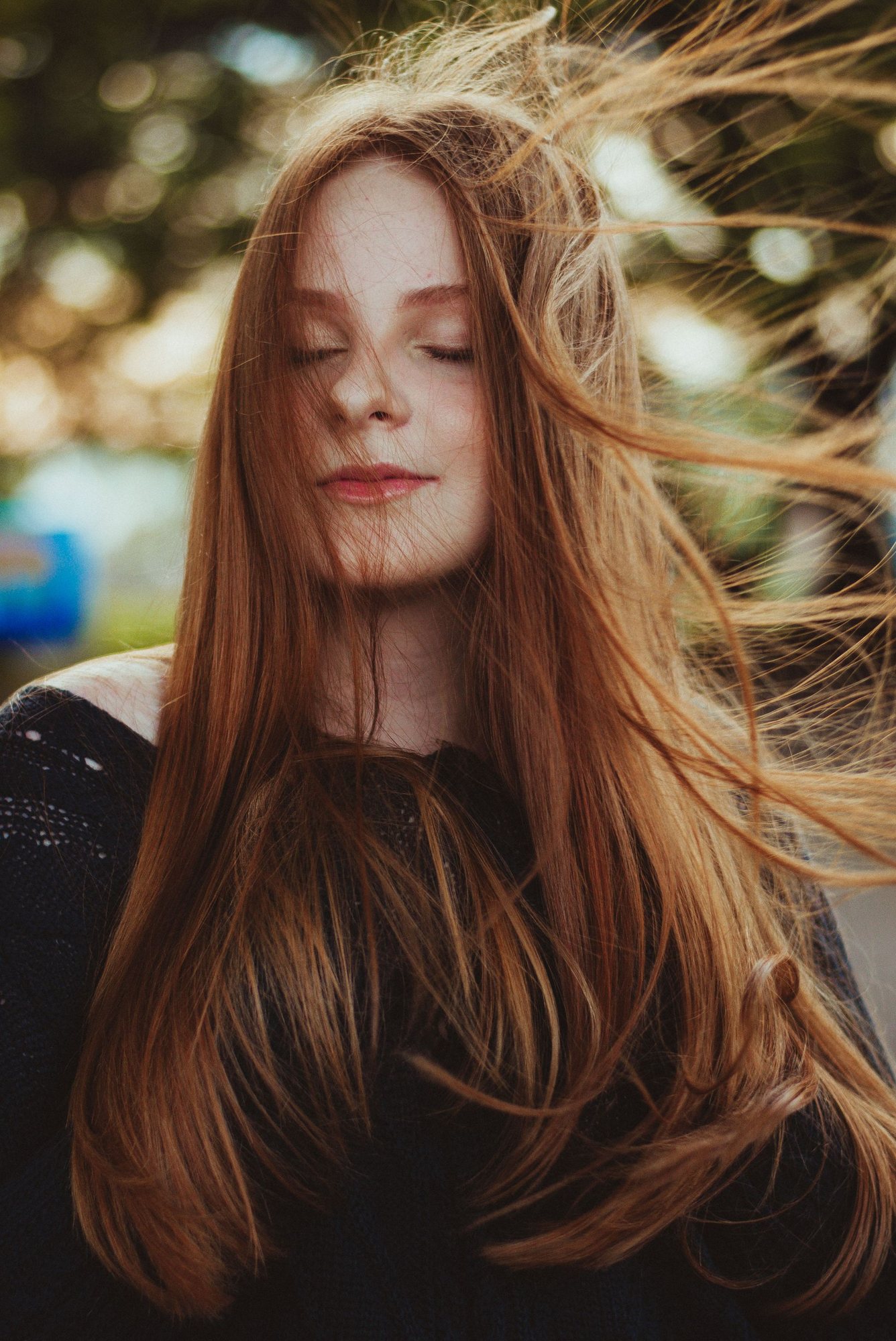 A woman with long hair blowing in the wind