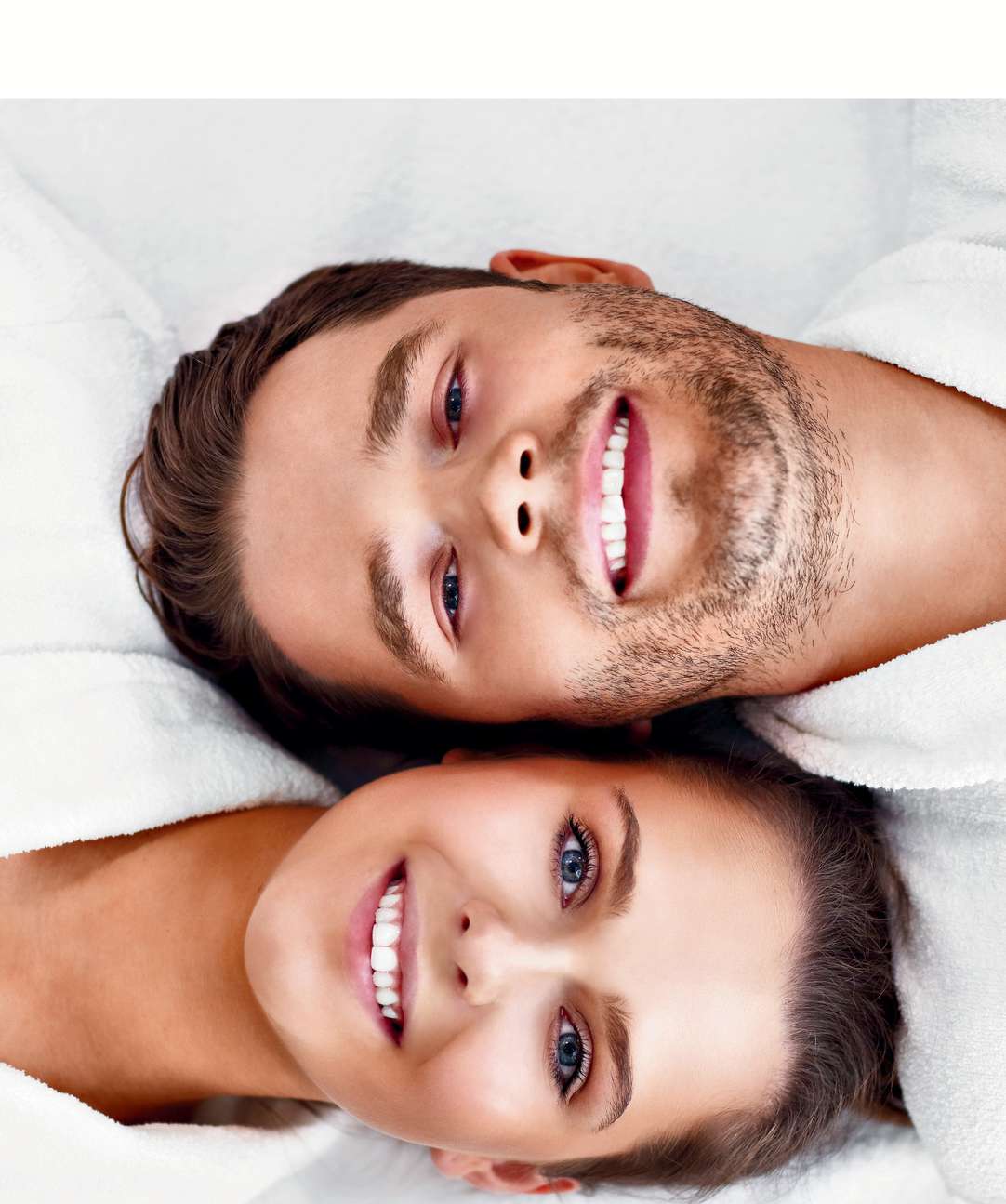 A smiling couple lying face to face