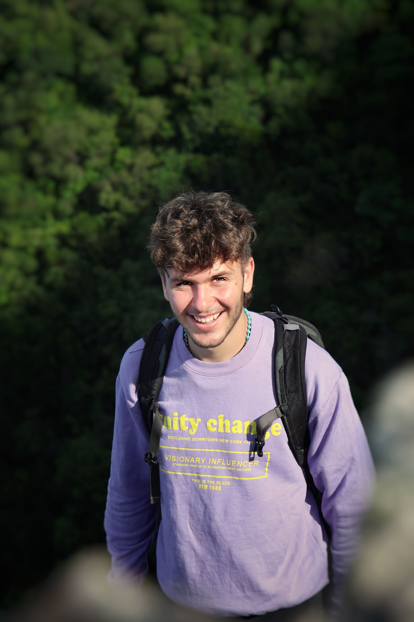 A smiling young man out hiking